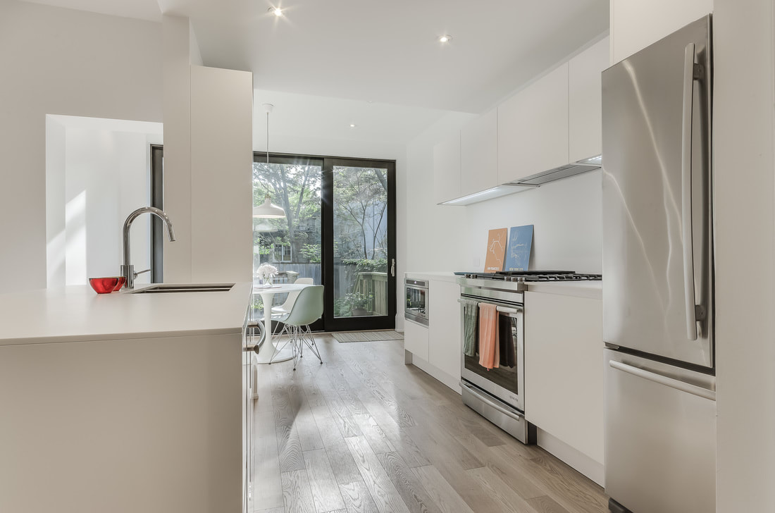 White matte lacquer painted doors, minimal kitchen, Golla profiles, stainless steel appliances, hidden exhausting 
